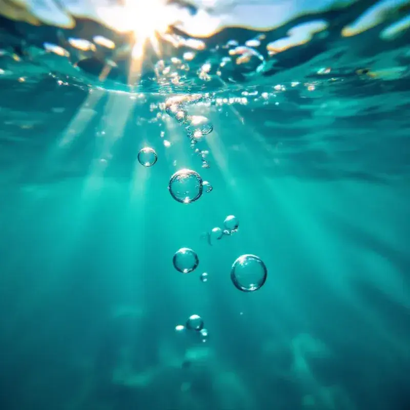 Abstract underwater bubbles rising in clear water