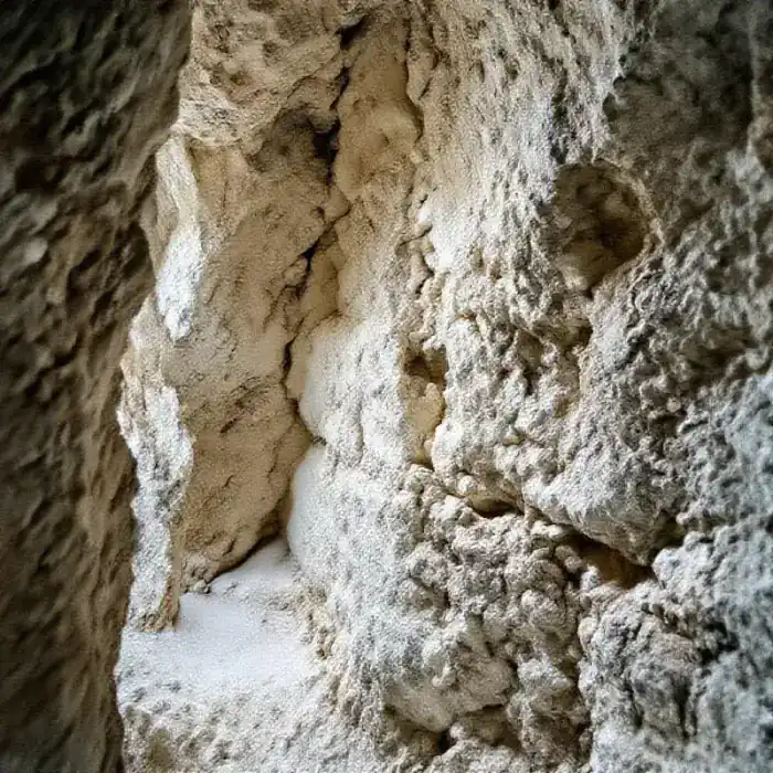 A close-up textural view of raw chalk rock wall in
